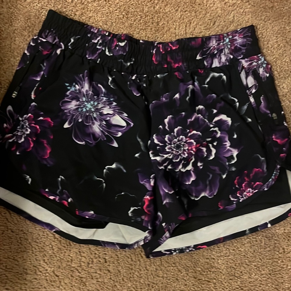 Black and purple workout shorts. Built in shorts underneath. Like new condition.